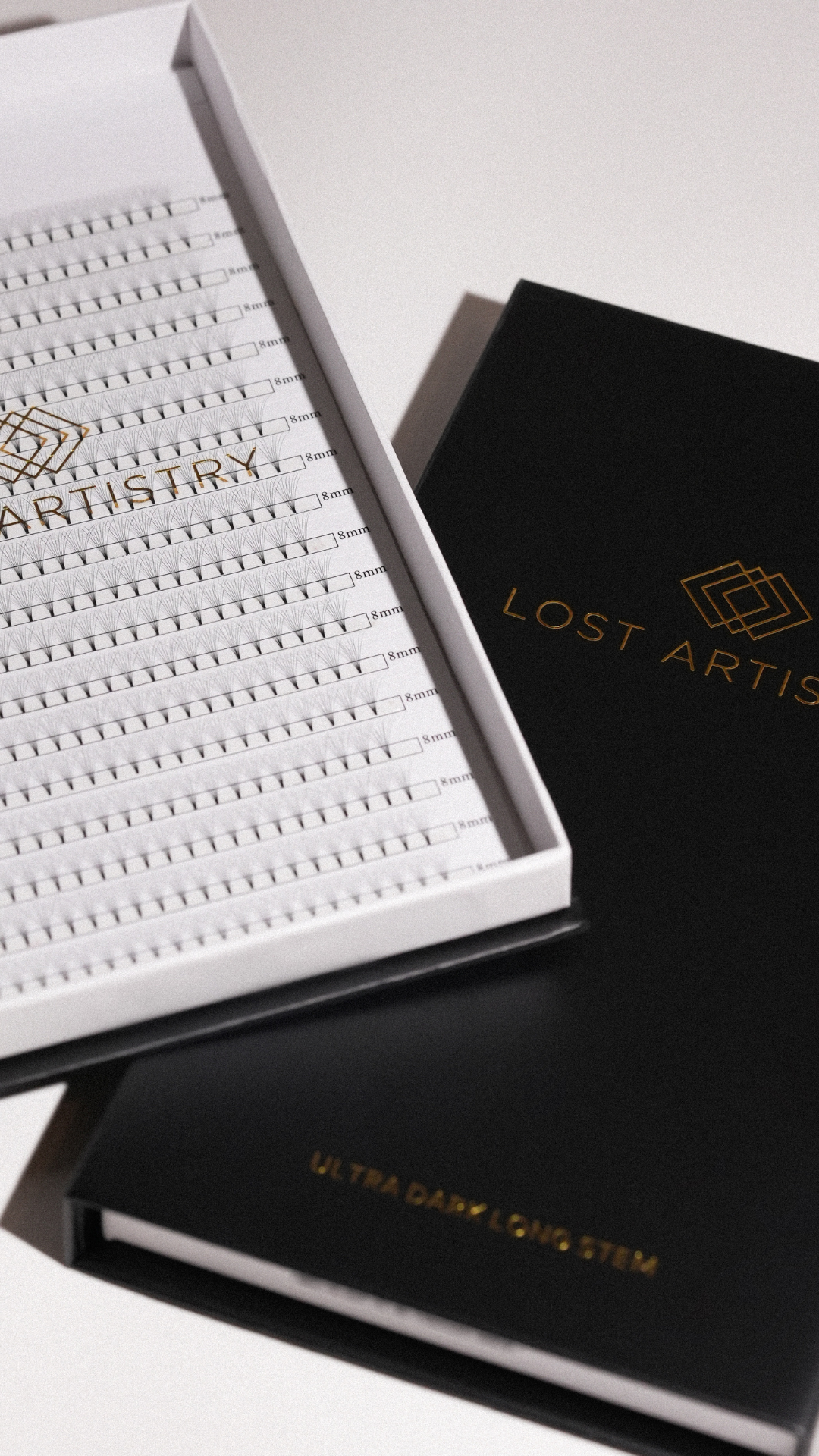Lost Artistry lash tray with ultra dark long stem extensions in a black and white branded box.