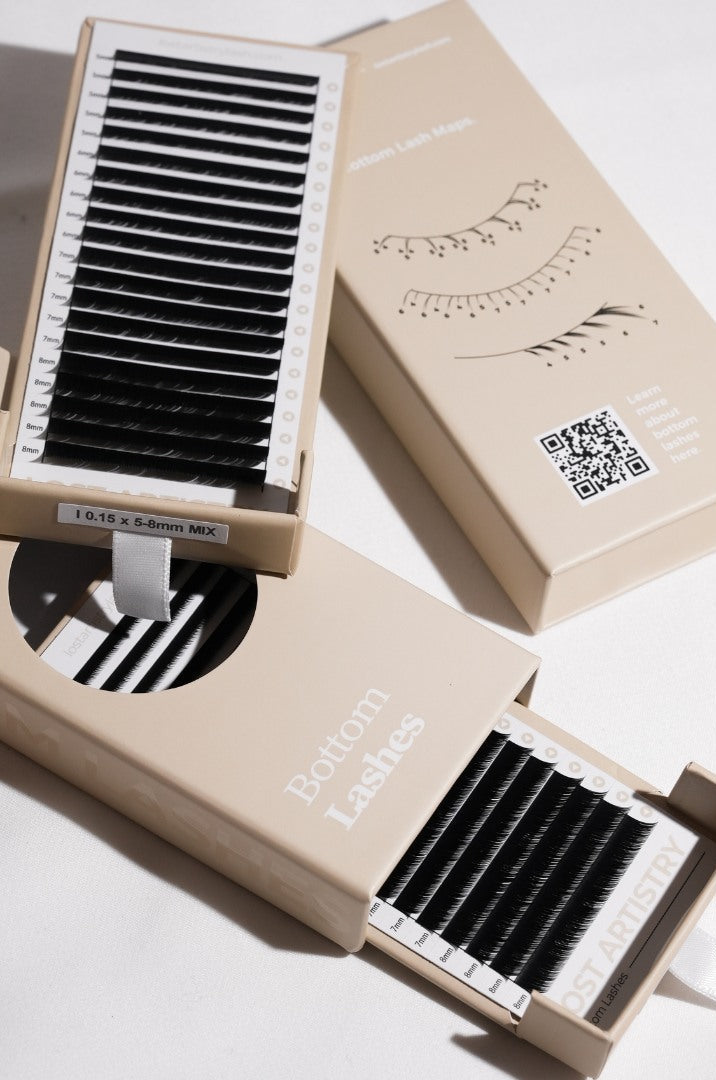 Eyelash extensions in open boxes on a light background