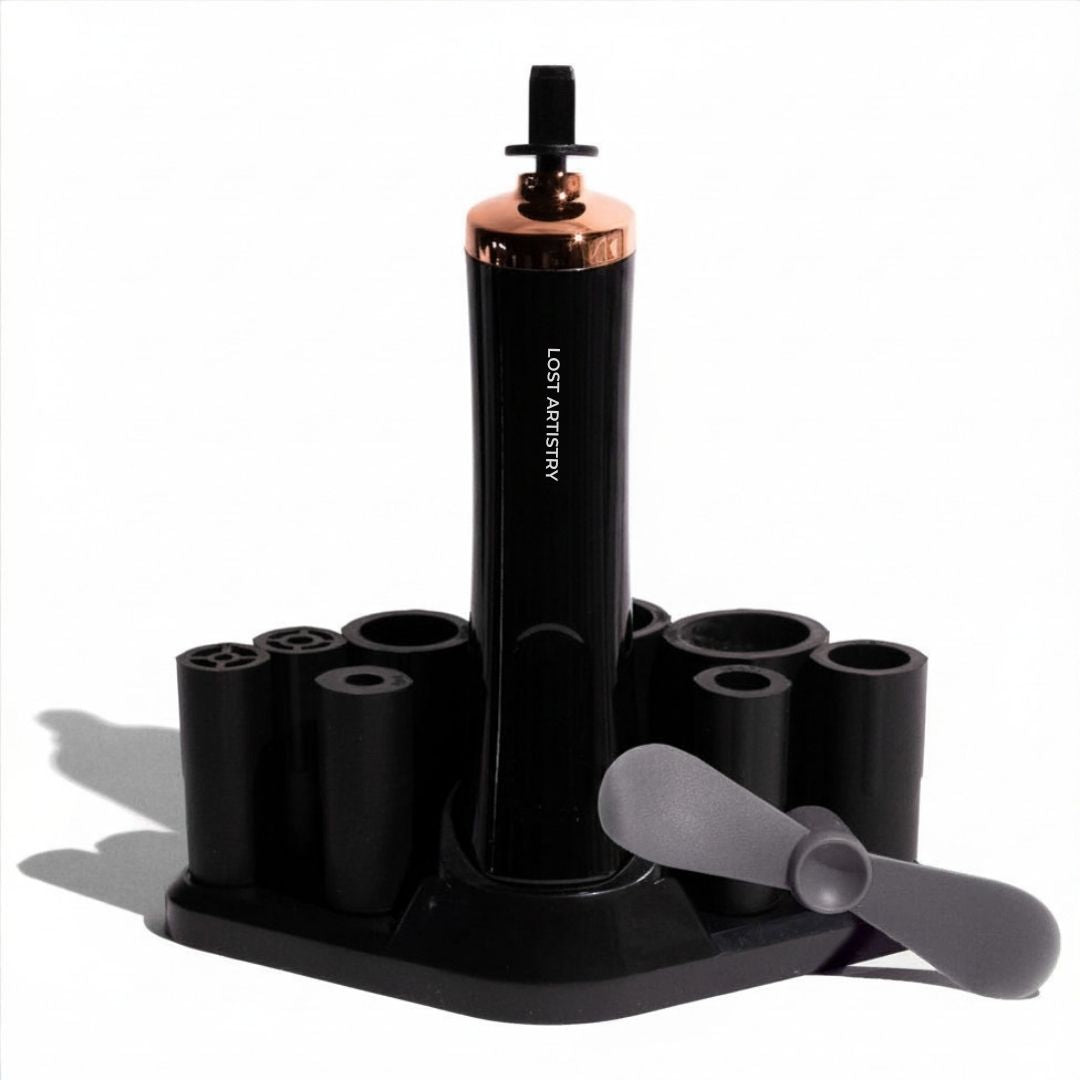 Black lash shaking device with rose gold accents on a white background