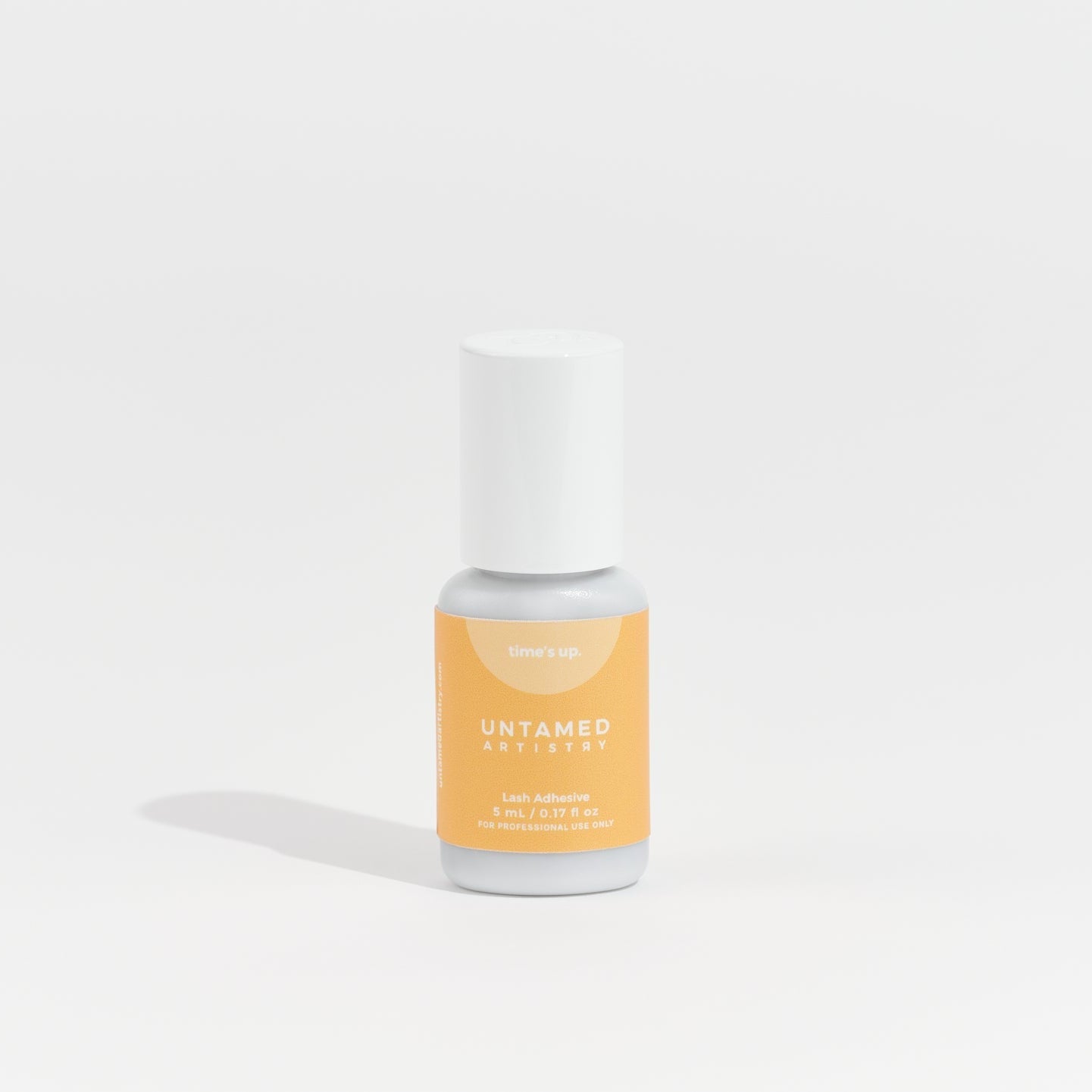 Bottle of nail polish with a white cap on a light gray background