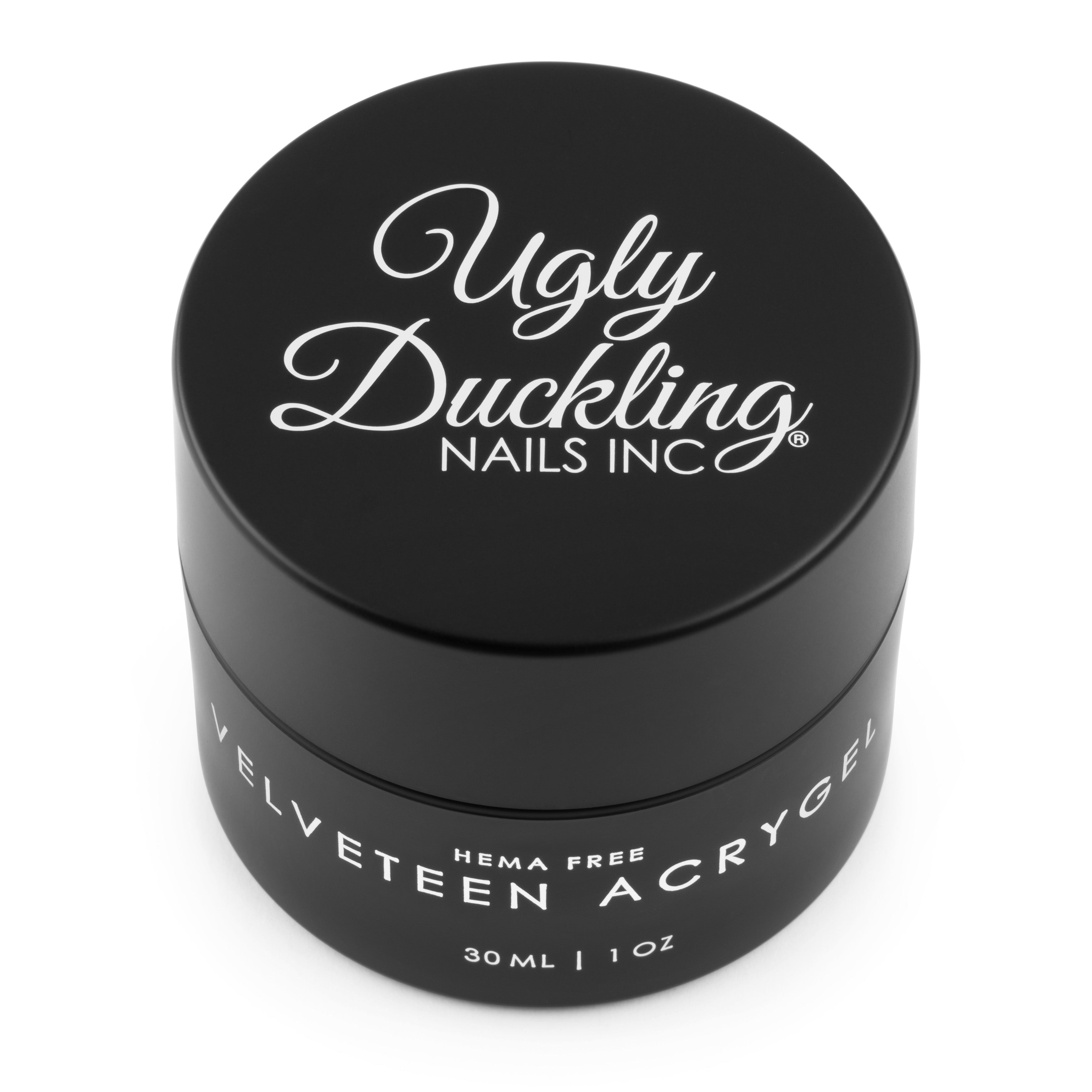 Black container of Ugly Duckling Nails Inc. velveteen acrygel on a white background
