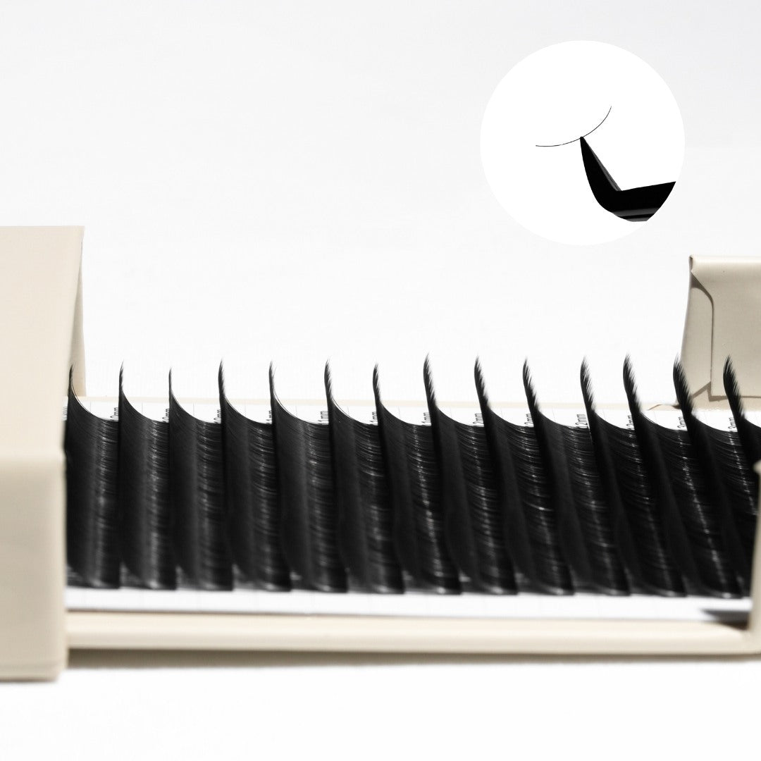 Close-up of false eyelashes in a packaging box with a brand logo.