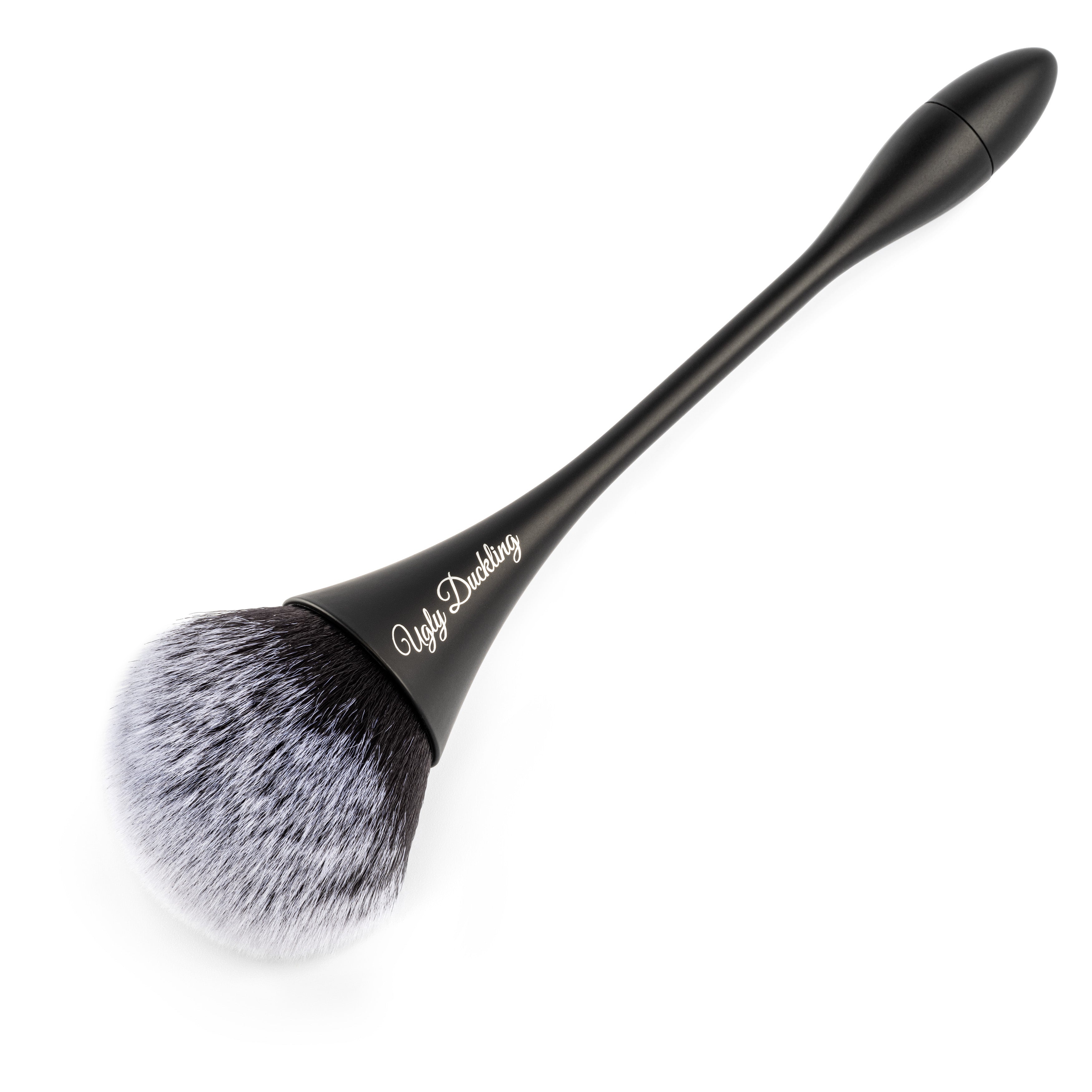 Makeup brush with black handle and bristles on a white background