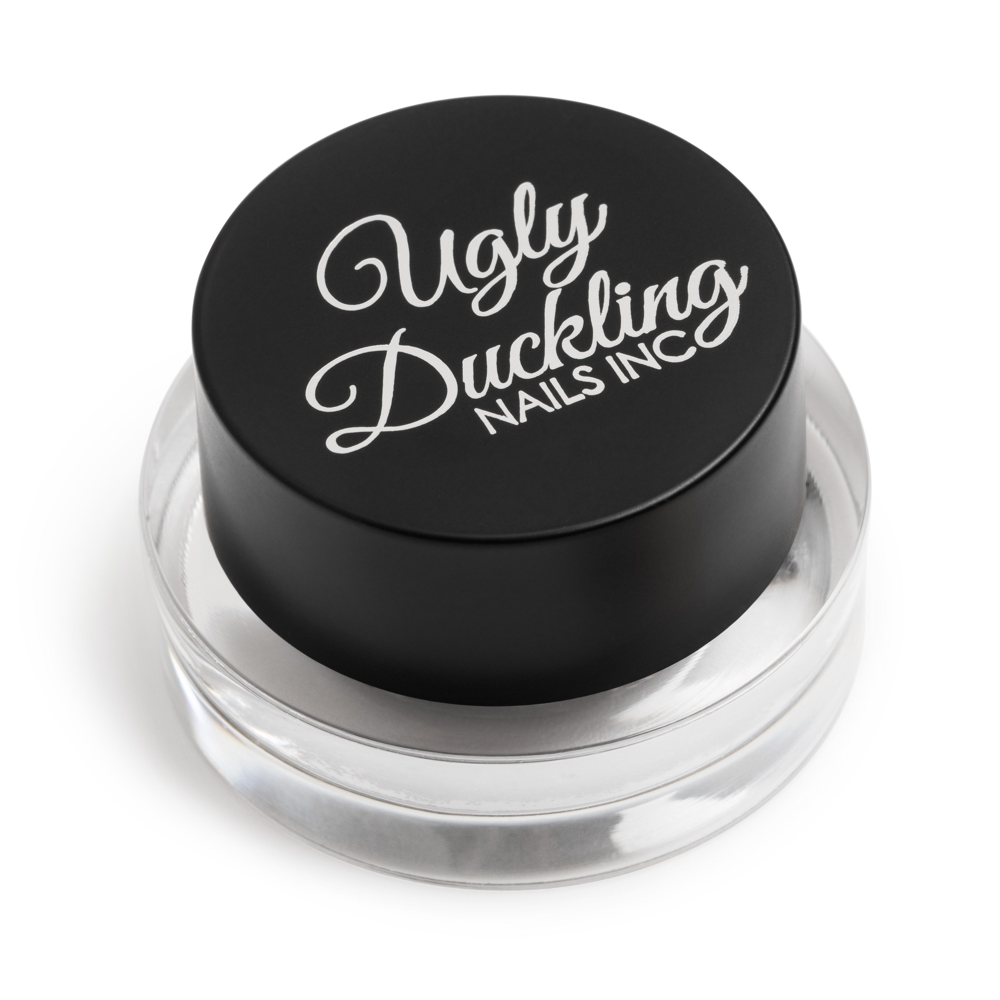 Cosmetic container with 'Ugly Duckling Nails Inc' lid on a white background