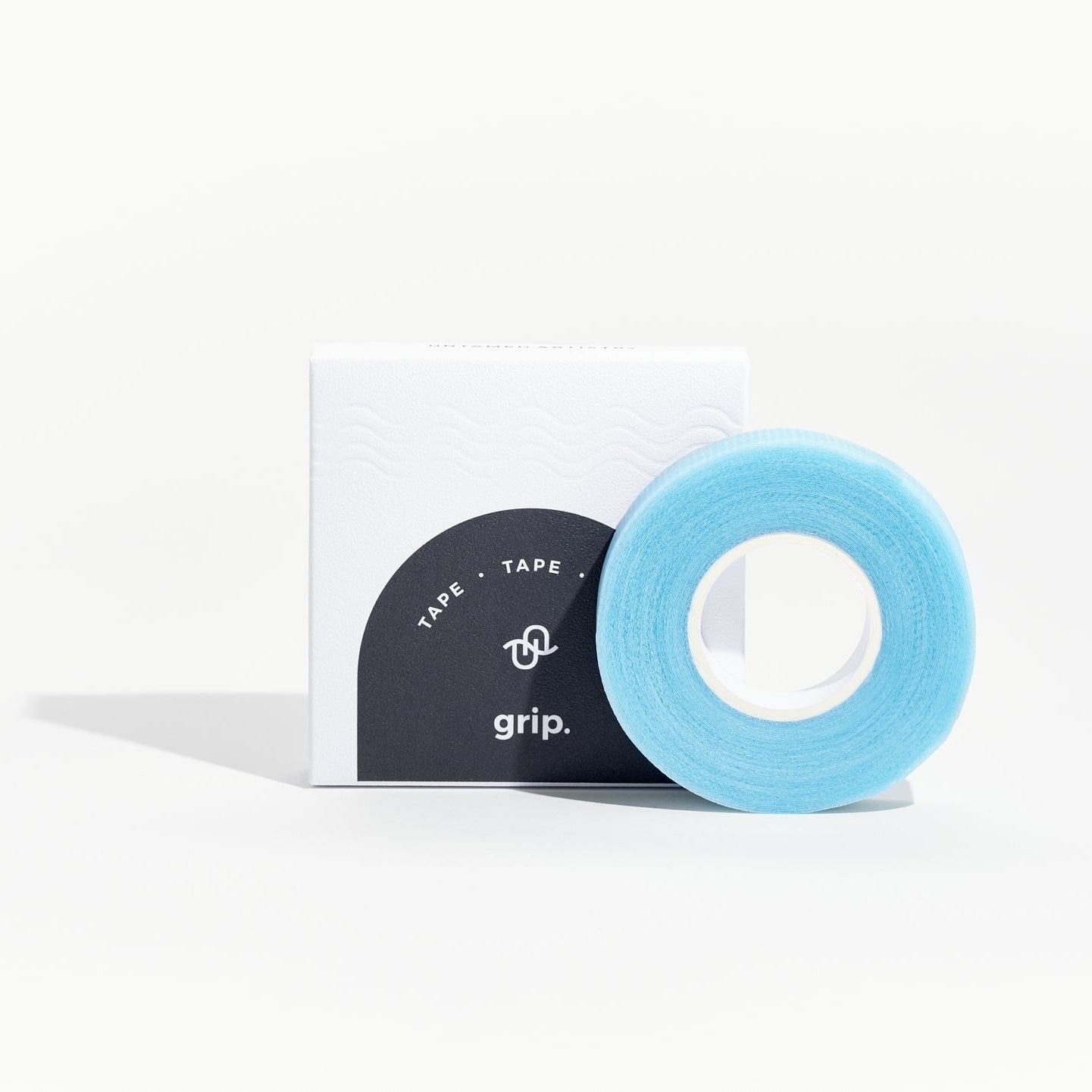 Roll of blue tape with a white box labeled 'grip' on a white background