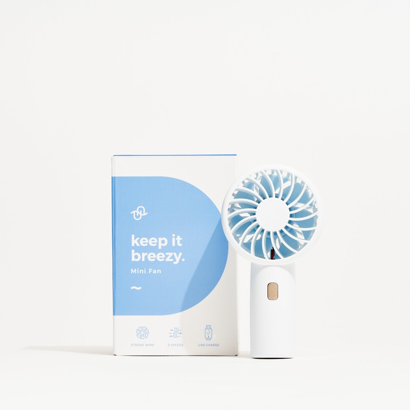 Portable fan with packaging labeled 'keep it breezy' on a white background