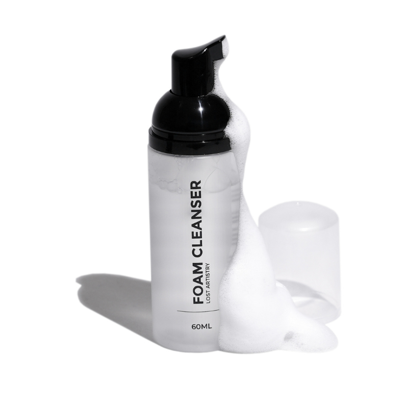 Foam cleanser bottle with black pump on a white background