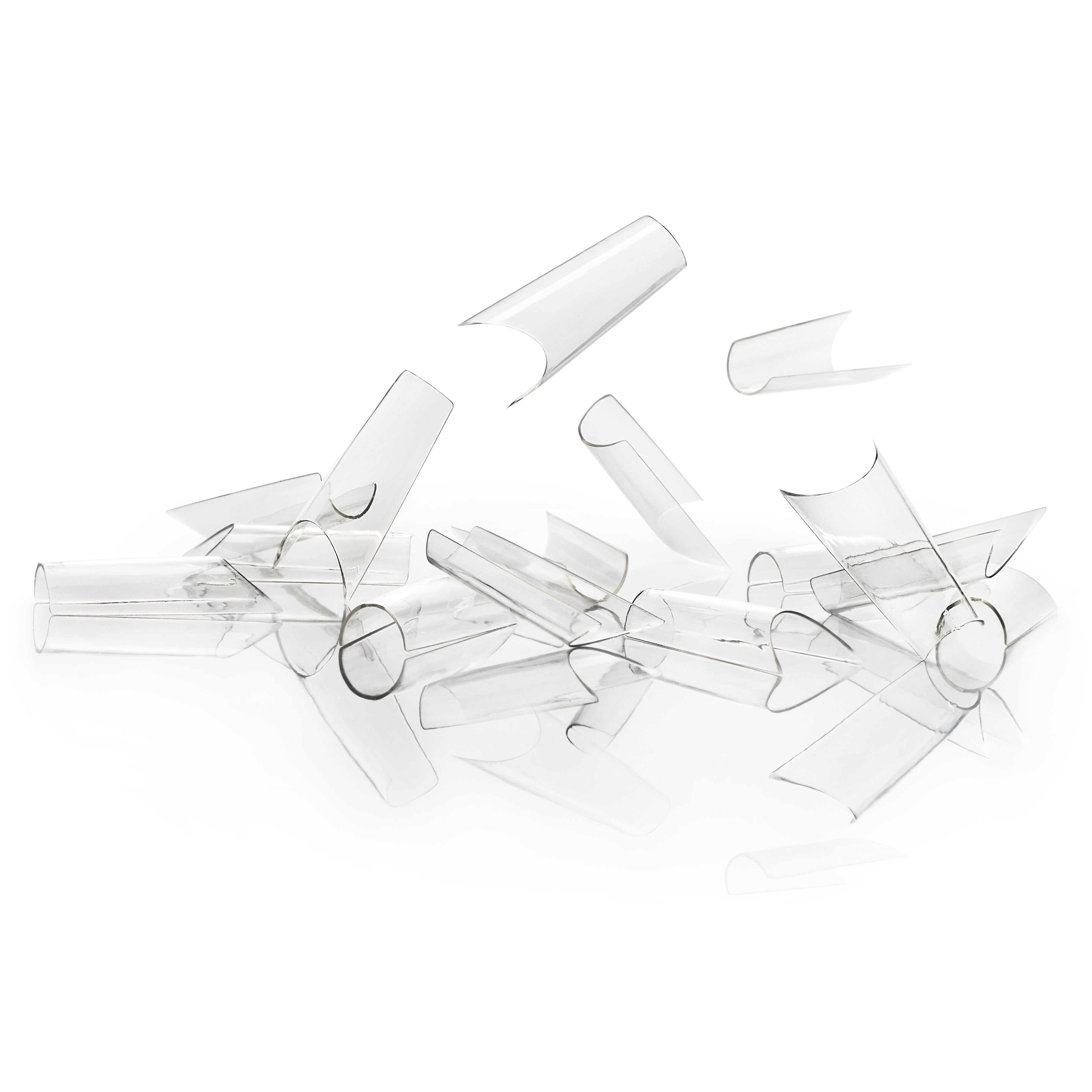 Clear plastic nail tips on a white background
