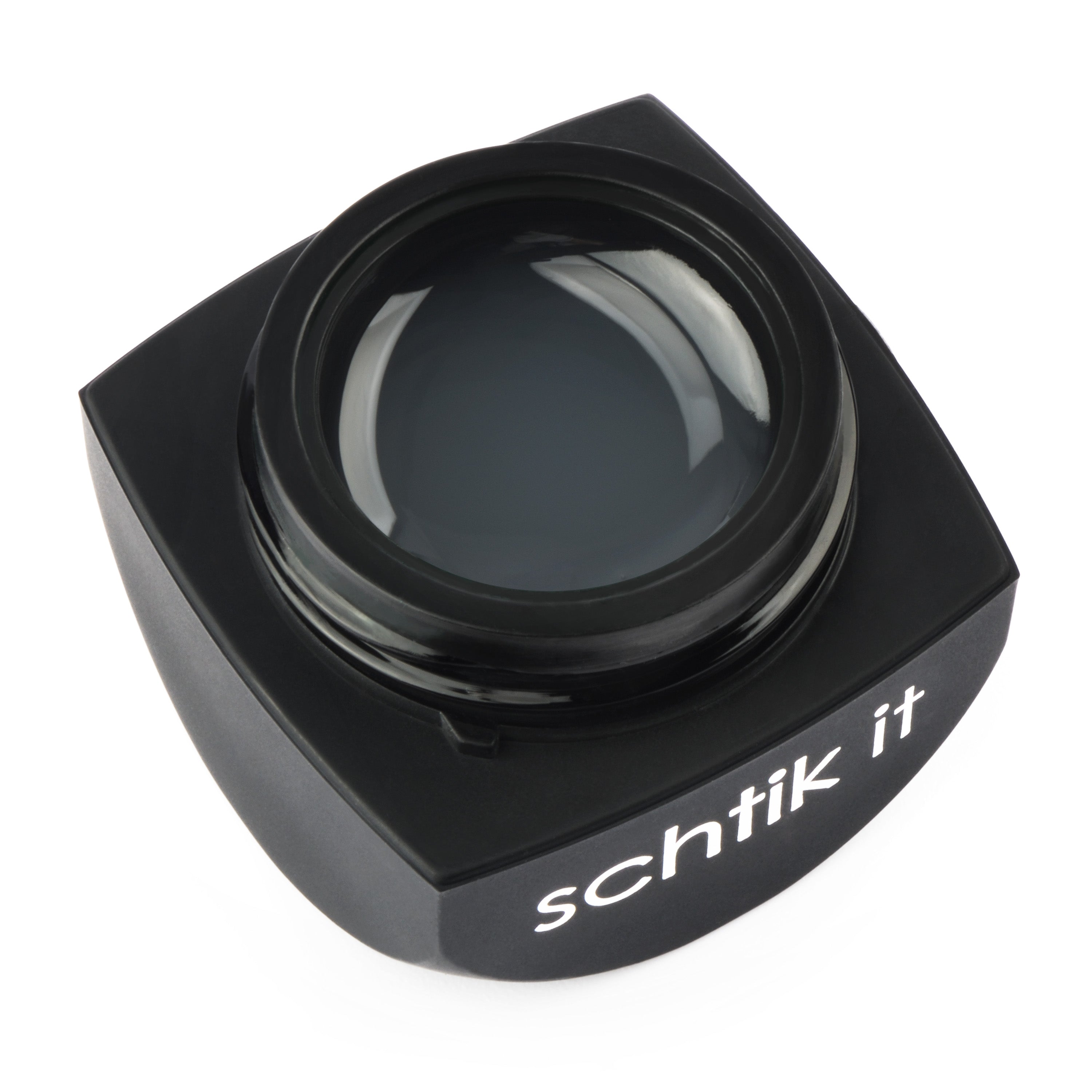 Black square bottle with 'schtik it' branding on a white background