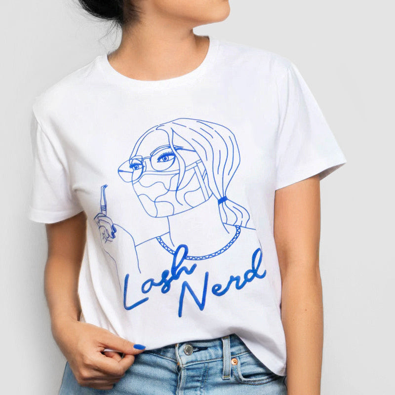Person wearing a white t-shirt with blue graphic and text 'Lash Nerd' on a plain background