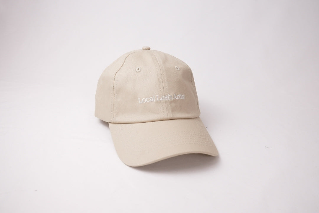 Beige cap with text on a white background